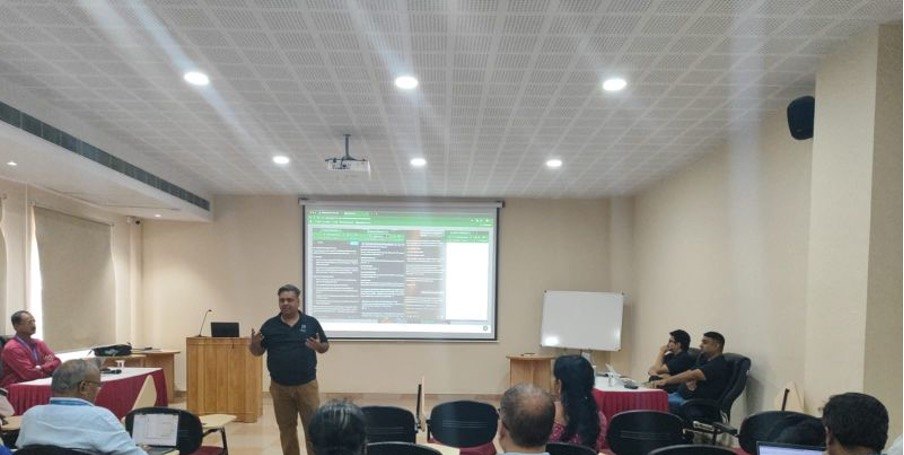 A Poorit trainer presenting to a seated audience at Christ University, Bengaluru